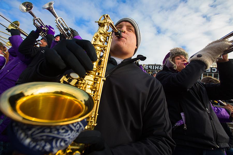 Ryan Schultz, of the Warhawk Marching Band, playing instrument at football game